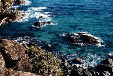 Looking down from a cliff edge to the Pacific Ocean