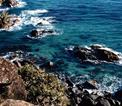 Looking down from a cliff edge to the Pacific Ocean